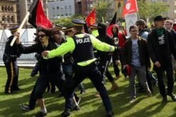 Pro- and anti- immigration protesters face off in duelling rallies